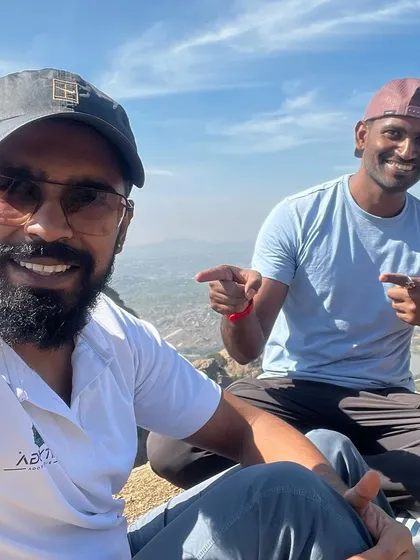 A happy selfie with a friend at the top of a mountain.