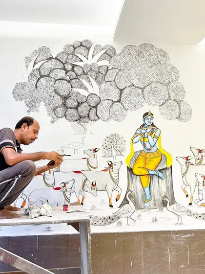 Here I am adding details to the peacocks and trees in the large Krishna mural. Every element is carefully considered to create a balanced and beautiful composition.