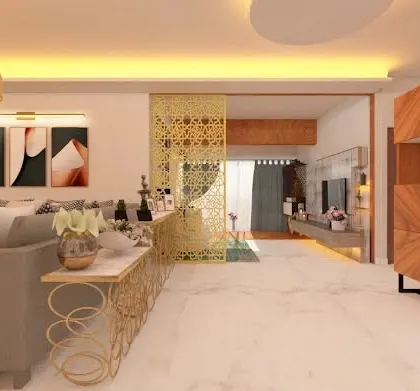 A view of the living space from behind the sofa, showing a golden jaali partition that separates the area while adding a decorative touch. The design incorporates a bar unit and console table, showcasing how we integrate multiple functions into one cohesive space.