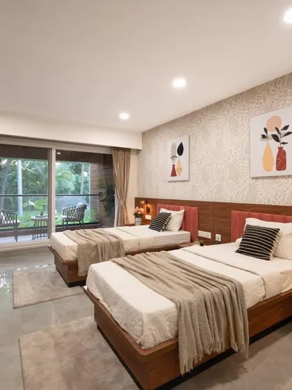 This twin-sharing room is perfect for accommodating multiple guests without sacrificing style. The design uses a neutral color palette, clean-lined wooden furniture, and coordinated artwork to create a restful and organized environment.