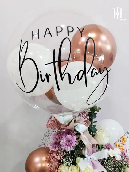 A close-up of the personalized birthday balloon, showing the elegant script and the mix of rose gold and white balloons inside. It's these small details that elevate a gift and make it feel truly special.
