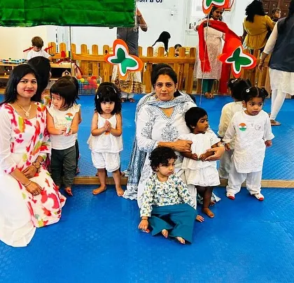 Another class group, dressed in white, poses for a photo to commemorate the celebration.