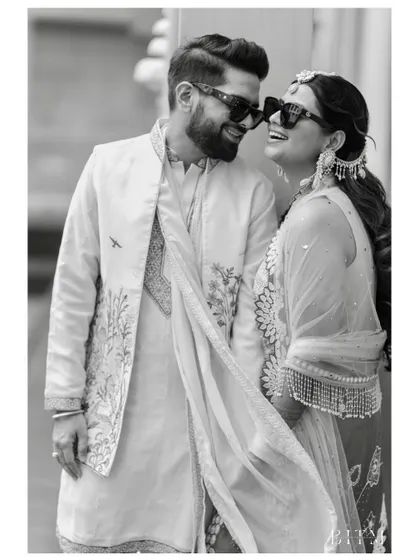 A laughing couple captured in a candid black and white shot. Their genuine joy and connection shine through, creating a timeless memory.