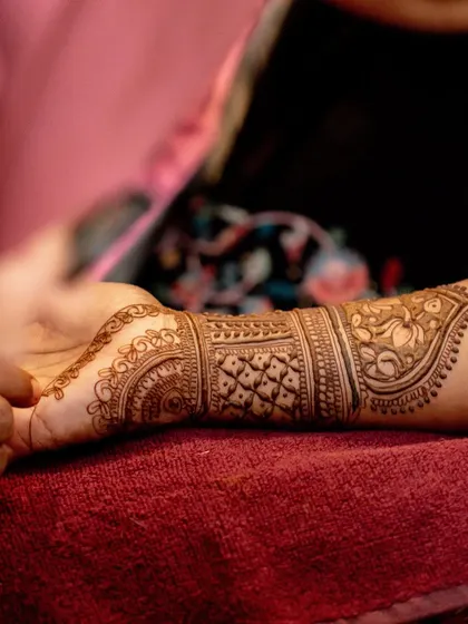 A beautiful and intricate bridal mehendi design in progress. This is a key part of the pre-wedding rituals, and we ensure the bride is comfortable throughout the process.