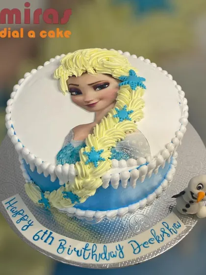 A lovely Rapunzel-themed cake featuring an edible image of the princess with her long, flowing hair made of yellow frosting. A little Olaf adds a fun Frozen crossover touch.