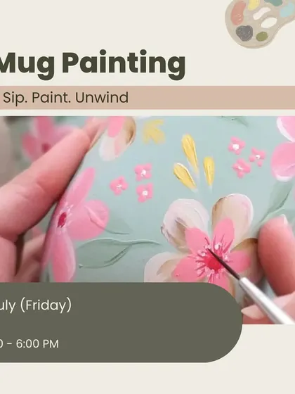 A promotional image for our mug painting workshop, showing a close-up of a brush adding delicate details to a floral mug design.