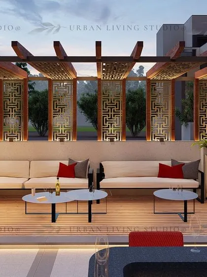 A large L-shaped sofa under a pergola with decorative jaali panels. This design is perfect for hosting larger groups in a stylish and comfortable setting.