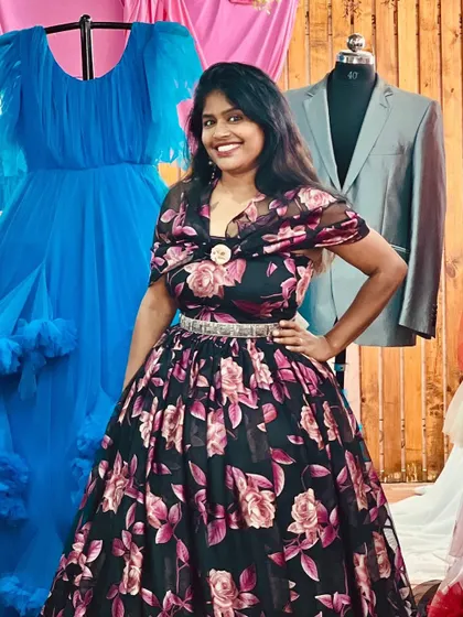 Here I am, Yashaswini, posing in our beautiful black floral gown. It's one of my personal favorites.