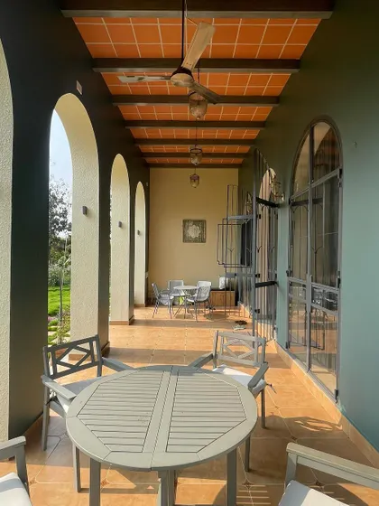 A similar perspective of the farmhouse veranda, highlighting the repetition of the arches that create a beautiful rhythm and frame views of the landscape.