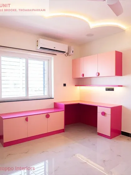 A vibrant pink study unit at Jain's Pebble Brooke, designed with an L-shaped desk and ample storage, creating a cheerful and productive workspace.