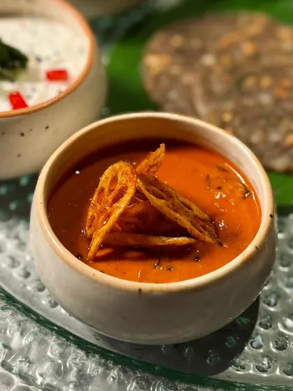 A close-up of one of the flavourful curries from our Navratri Thali, garnished with crispy lotus stem chips.