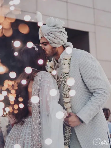 A kiss of love and promise, surrounded by the soft glow of bokeh lights. A truly magical and romantic wedding portrait.