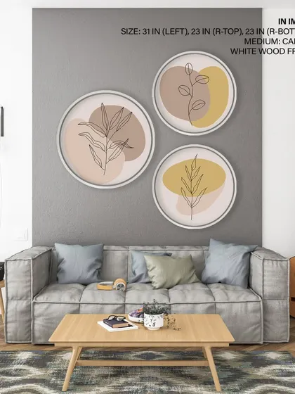 A chic set of three circular art prints with botanical line drawings on pastel backgrounds. The white wood frames and minimalist design make this a versatile choice for a modern and airy living room.