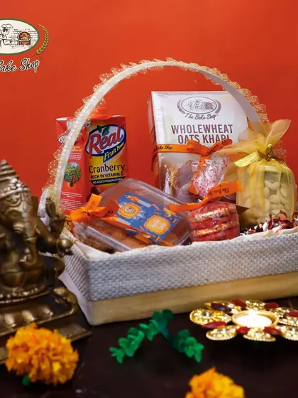 A luxurious custom Diwali hamper basket, showcasing a mix of our baked goods, nuts, and juices. We can create custom hampers to suit your specific gifting needs for the festive season.