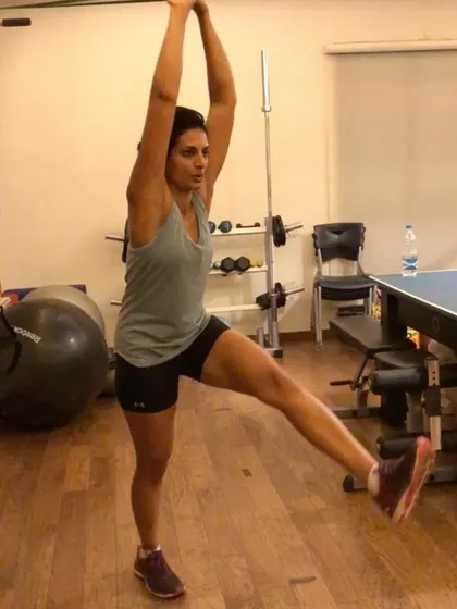 A shot of a client performing a dynamic stretch. Flexibility and mobility are just as important as strength, and we incorporate them into our routines.