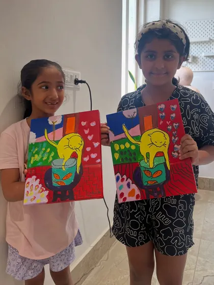 Two friends with their matching cat paintings. It’s fun to see how they interpreted the same subject with their own choice of colors and details.