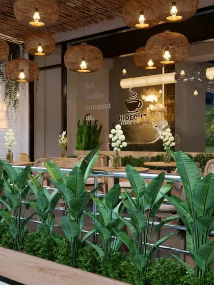 From this angle, you can see the seamless flow from the outdoor planters to the interior greenery. We used plants to blur the lines between inside and out, creating a refreshing and cohesive eco-friendly cafe design.