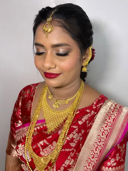 Ambar looked stunning for her wedding. I used a shimmery eyeshadow to make her eyes pop and a classic red lip to complement her beautiful red saree.