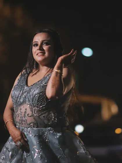 Every moment is a treasure. A candid shot of the bride at night, with the city lights blurred in the background, creating a beautiful and atmospheric portrait.