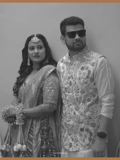 A stylish black and white portrait of the couple, showcasing their modern yet traditional outfits.