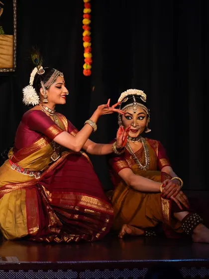 Radha being adorned by Krishna. Small, tender gestures are choreographed into the duet to show the affection underlying their argument.
