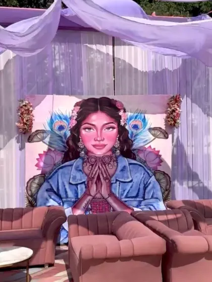 A comfortable and stylish lounge seating area for guests, set against a large, custom-painted backdrop that was a major photo attraction.