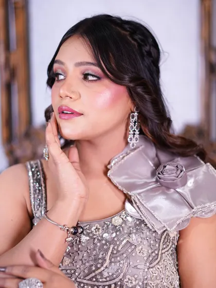 A close-up portrait in the grey satin gown, highlighting the intricate beadwork.