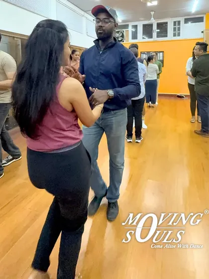 Our classes are a diverse mix of people, all here for the love of dance. Here, students are learning the basic side-to-side step, a fundamental movement in Salsa.