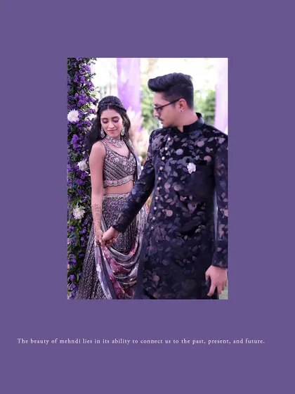 A romantic portrait of the couple, framed by the beautiful purple floral decor of their Mehendi event.