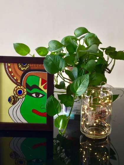 This is my tribute to the culture of Kerala, a Kathakali face painting. The striking green and intricate details represent the classic characters from this traditional dance form. It comes framed and ready to add a touch of drama to your wall.