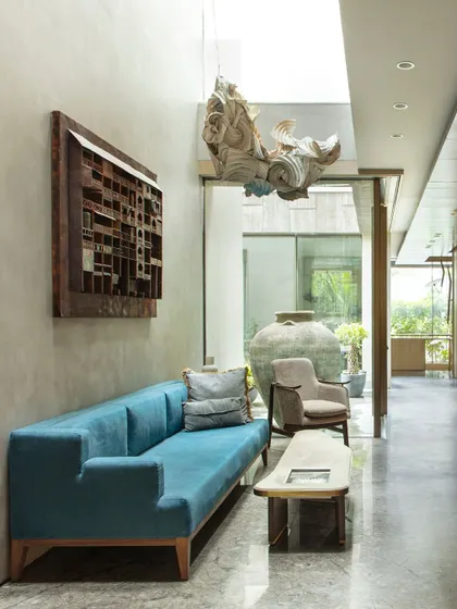 A bright, airy view of the family lounge where the intricate origami light installation hangs like a cloud. The piece complements the natural light and provides a focal point that is both artistic and functional.