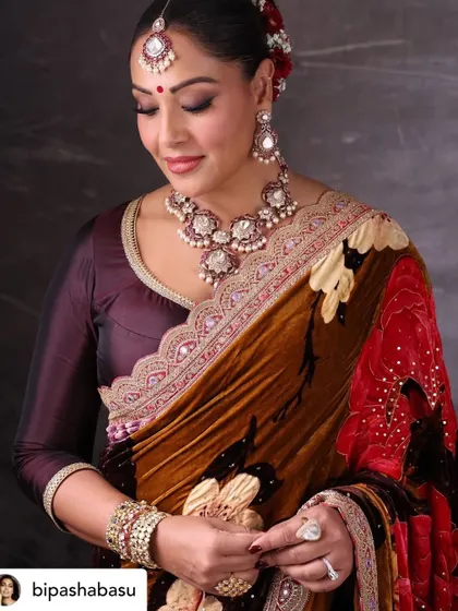 A close-up portrait of Bipasha Basu, focusing on the intricate details of her jewellery and the soft expression.