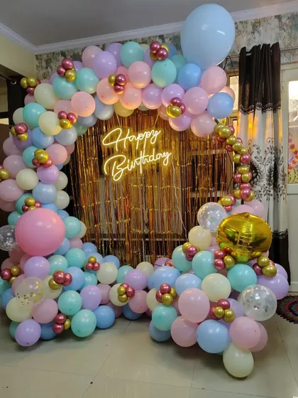 Another angle of the pastel balloon and gold shimmer curtain backdrop, showing the mix of colors and textures.