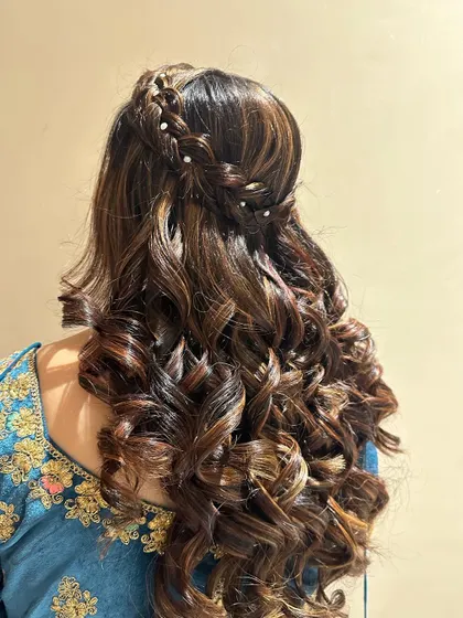 Another variation of the popular open hairstyle with soft curls and a braided crown. This is a versatile look for any pre-wedding event.