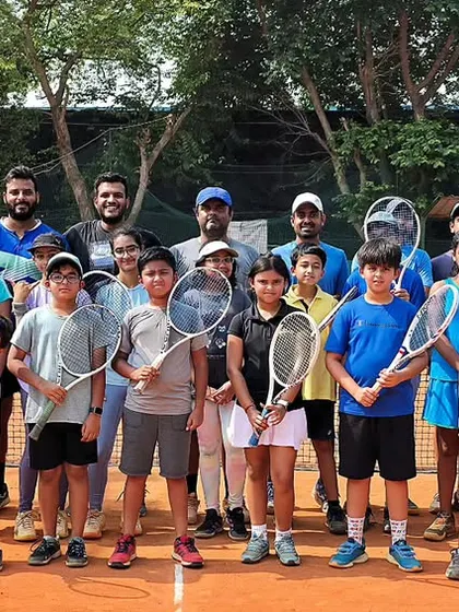 The Tennis Vidyalaya family. A group photo of our players and coaches on the court, fostering a sense of team and community that is vital for growth and support.