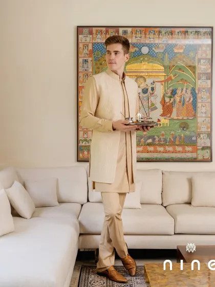 Our beige layered kurta set, perfect for festive ceremonies. The clean, elegant lines and neutral color make it a versatile and sophisticated choice for any traditional event.