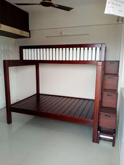 A full view of the solid wood bunk bed with storage stairs. The two-tone finish with white railings adds a touch of modern contrast to the classic dark wood frame.