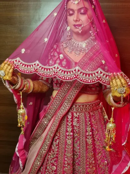 This stunning bride in her red lehenga is a perfect example of a classic North Indian bridal look. We focused on radiant skin, bold eyes, and a traditional bridal bun adorned with flowers.