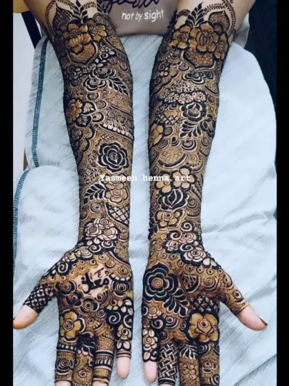 A beautiful example of a heavy floral bridal design. The arms are covered in a tapestry of roses and leaves, creating a rich and luxurious look for the bride.