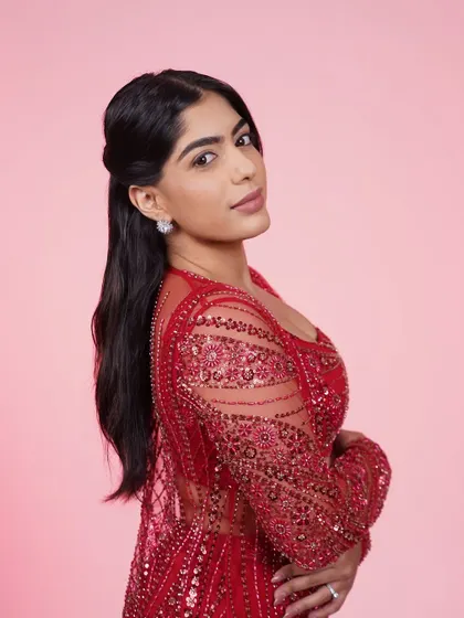 A close-up of the red three-piece set, focusing on the beautiful sequin work on the jacket and top.