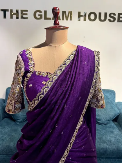 A close-up of the purple half saree, showing the intricate embroidery on the blouse and the delicate border of the dupatta.