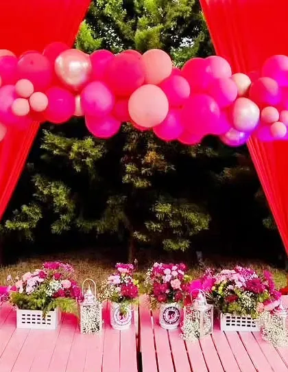 A pink canopy with balloon garlands and low seating created a cozy and magical space for kids at the Barbie-themed sundowner party.