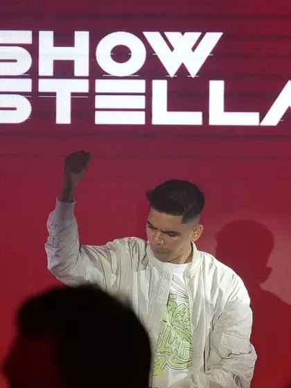 Commanding the stage at Brillo, Nagpur, with my logo displayed prominently on the massive red screen behind me.