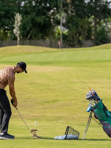 This image captures the moment of impact during a short game drill. Our practice areas allow for focused repetition to master these critical scoring shots.