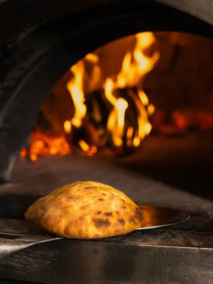 Embrace the taste of tradition with my freshly baked Ciabatta bread, puffed up and golden from the heat of the wood-fired oven.