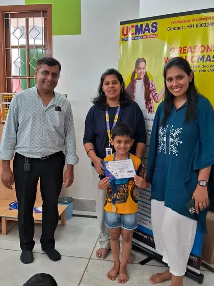 Another successful student with his proud parents and teacher. Community and support are key to our programs.