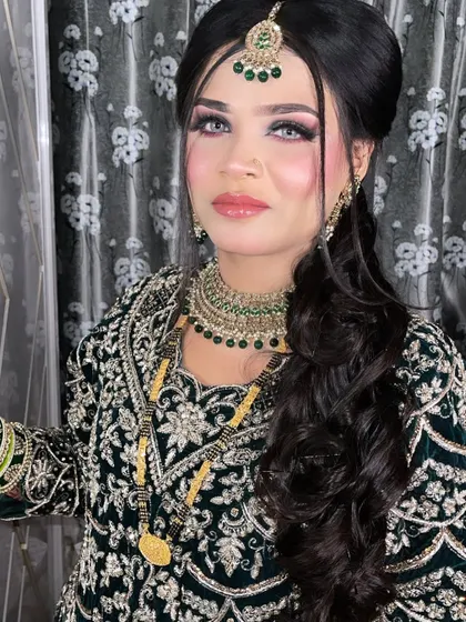 Mesmerizing beauty. Our beautiful bride is ready for her Walima in a stunning dark green outfit with dramatic eye makeup and glossy lips.