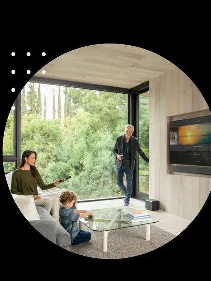 Our smart home solutions are designed for the whole family to enjoy. Here, a family interacts with their integrated entertainment and comfort systems in a modern living space, demonstrating how our technology enhances daily life and brings people together.