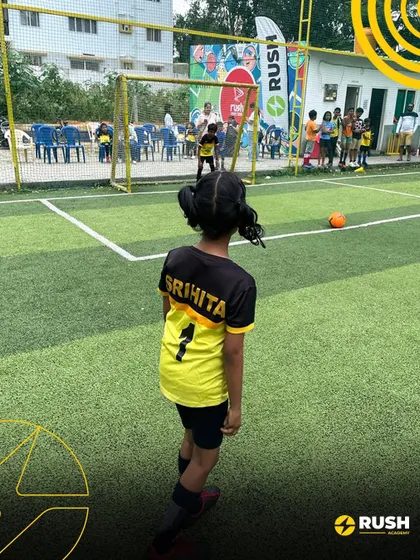 A young female player prepares to take a free-kick during a friendly match, showcasing her focus and determination.