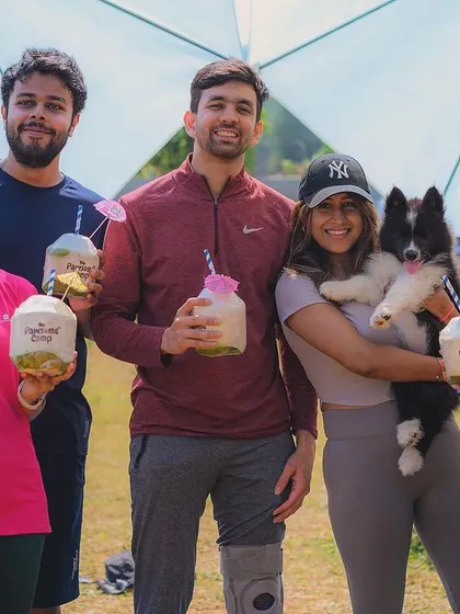 The Pawga (puppy yoga) crew enjoying some refreshing post-workout coconuts.